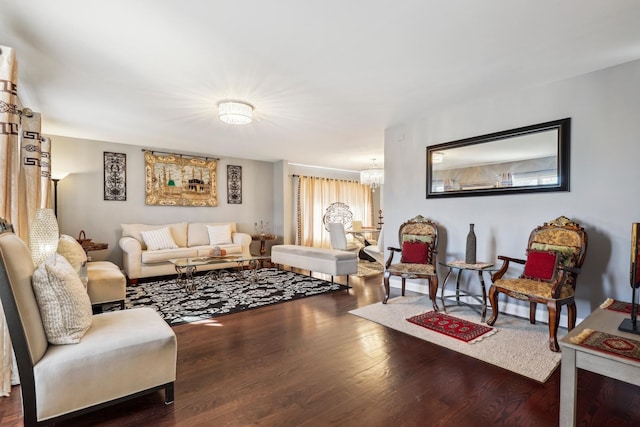 living room featuring an inviting chandelier and wood-type flooring