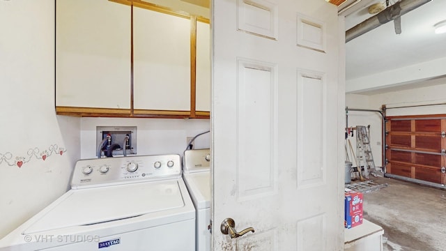 laundry room with separate washer and dryer and cabinets