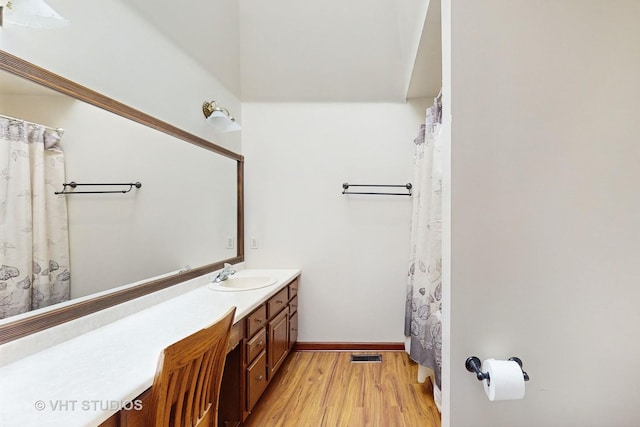 bathroom with vanity and hardwood / wood-style flooring