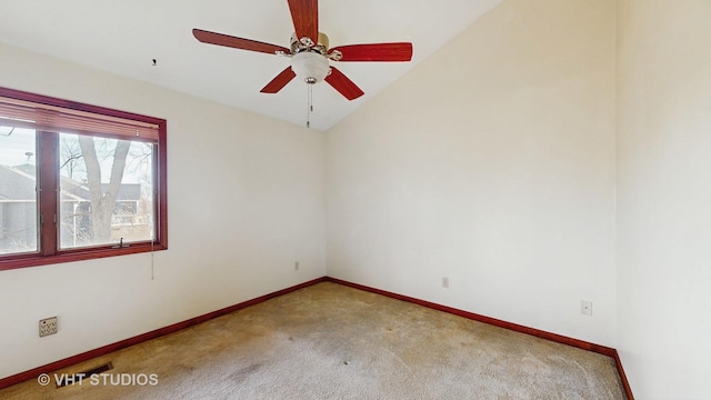 unfurnished room with vaulted ceiling, ceiling fan, and carpet flooring