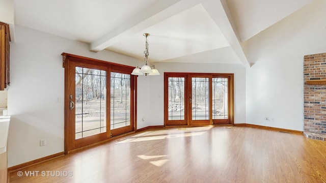 interior space with beam ceiling, light hardwood / wood-style flooring, and a notable chandelier