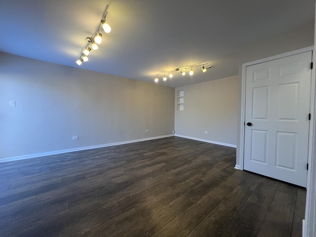 unfurnished room featuring dark wood-type flooring