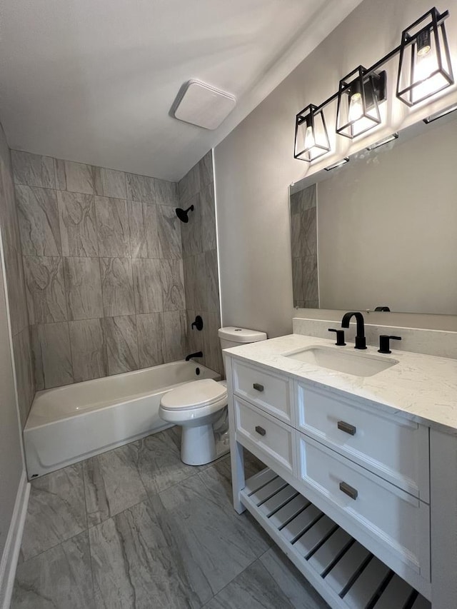 full bathroom with tiled shower / bath, vanity, and toilet