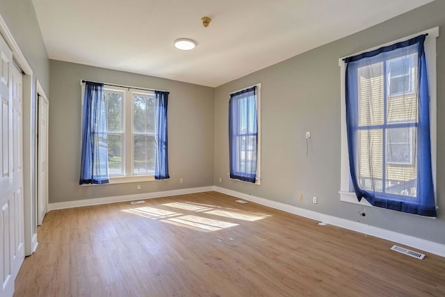 unfurnished room with light hardwood / wood-style floors