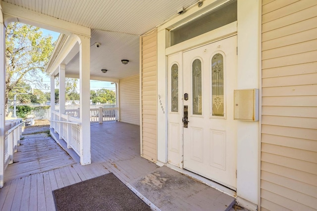 view of exterior entry with a porch