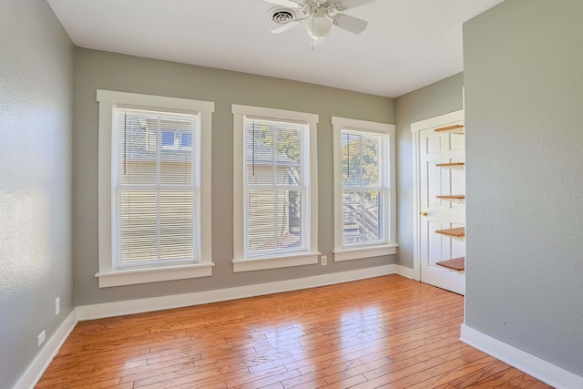 spare room with ceiling fan and light wood-type flooring