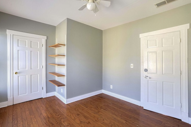 unfurnished room featuring dark hardwood / wood-style floors and ceiling fan