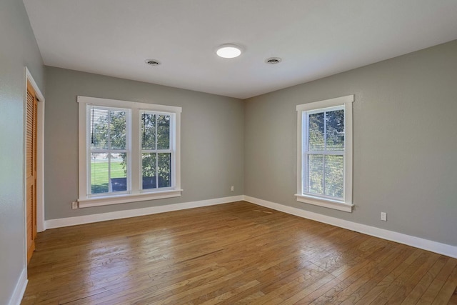 spare room with hardwood / wood-style floors