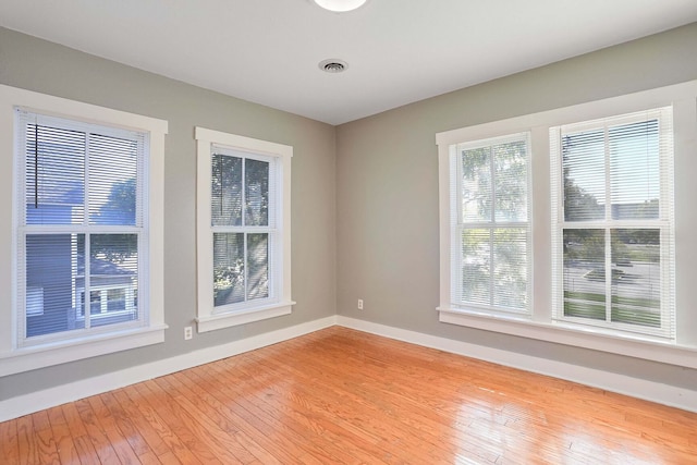 empty room with light hardwood / wood-style floors