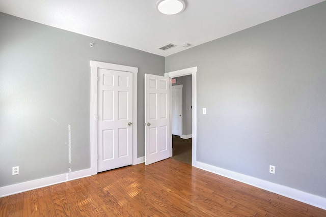 unfurnished bedroom featuring hardwood / wood-style floors