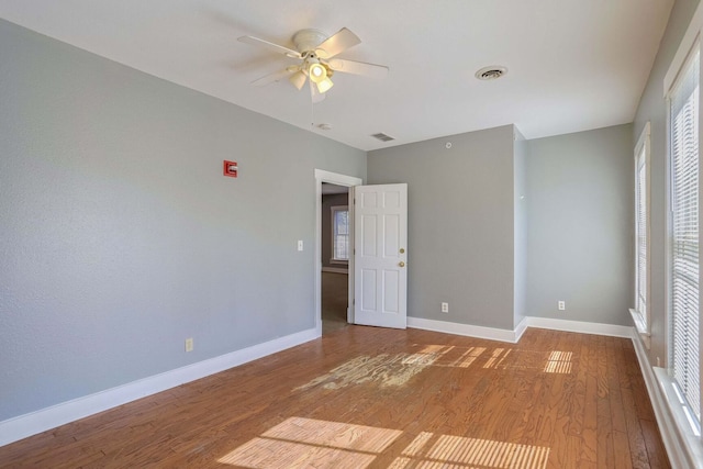 empty room with wood-type flooring and ceiling fan