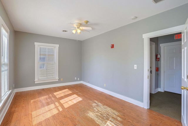 empty room featuring ceiling fan and light hardwood / wood-style flooring