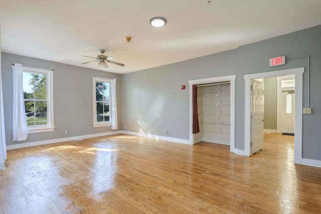 unfurnished room with ceiling fan and light wood-type flooring