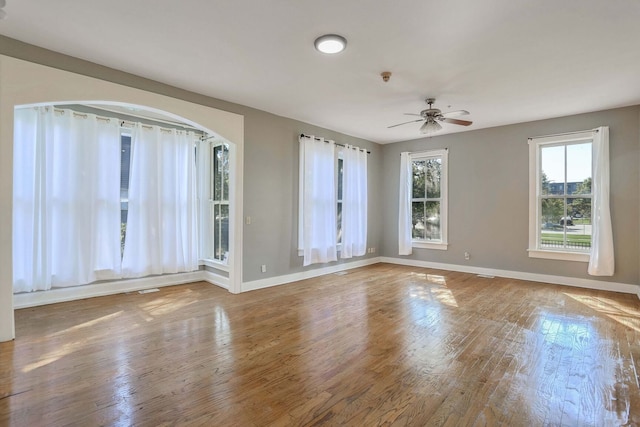 empty room featuring hardwood / wood-style flooring and ceiling fan