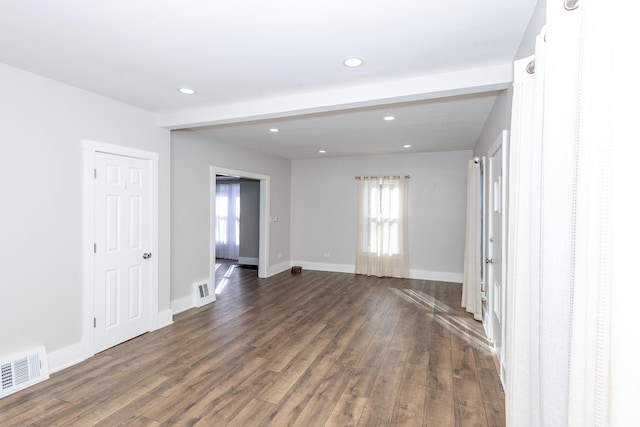 spare room featuring dark wood-type flooring