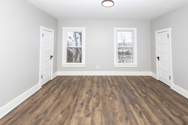 unfurnished room featuring dark hardwood / wood-style flooring