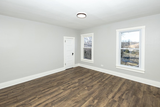 unfurnished room featuring dark hardwood / wood-style flooring