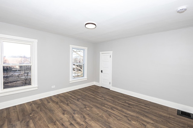 spare room featuring dark wood-type flooring