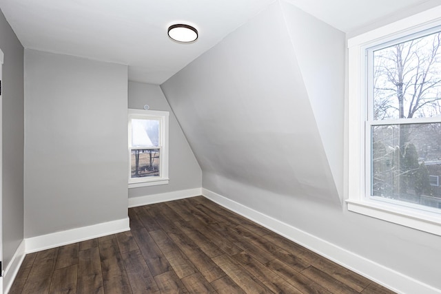 additional living space featuring dark hardwood / wood-style flooring and vaulted ceiling