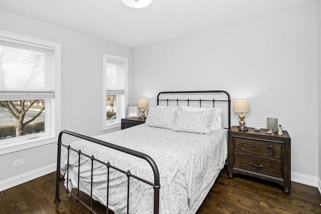 bedroom featuring baseboards and wood finished floors