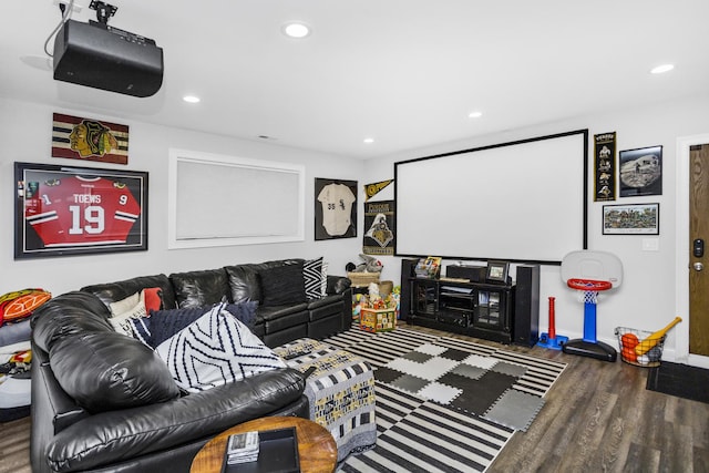 cinema room with baseboards, wood finished floors, and recessed lighting