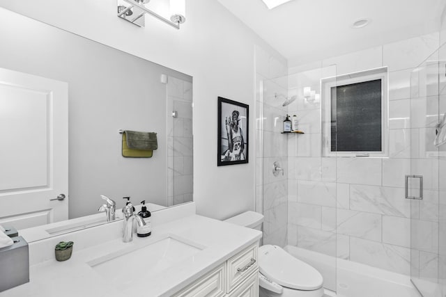 full bathroom featuring vanity, a shower stall, and toilet