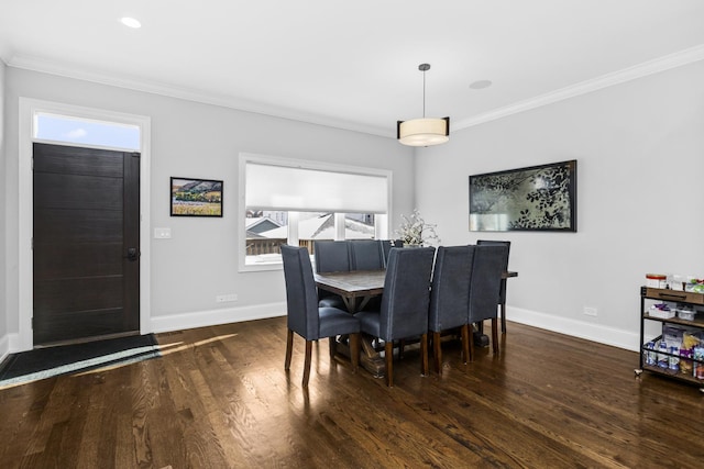 dining area with ornamental molding, baseboards, and wood finished floors