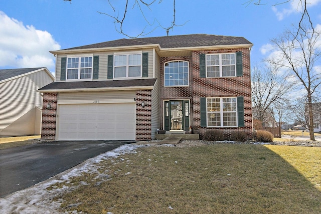 view of front of property with a garage and a front yard