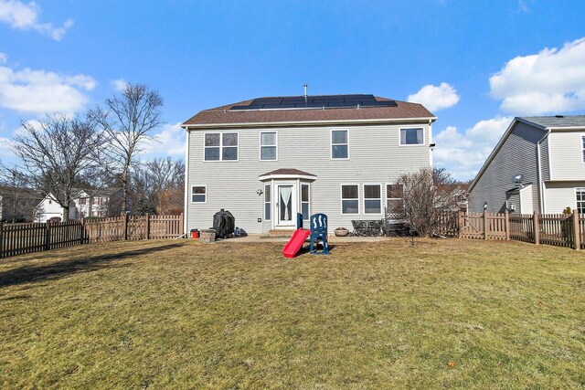 snow covered rear of property with solar panels