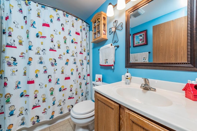 bathroom with walk in shower, tile patterned floors, toilet, and vanity