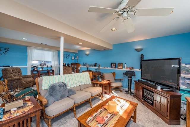 carpeted living room with ceiling fan