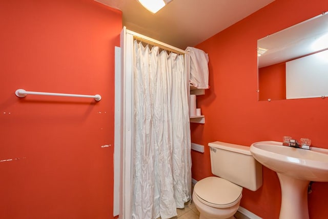 bathroom featuring sink, tile patterned floors, and toilet