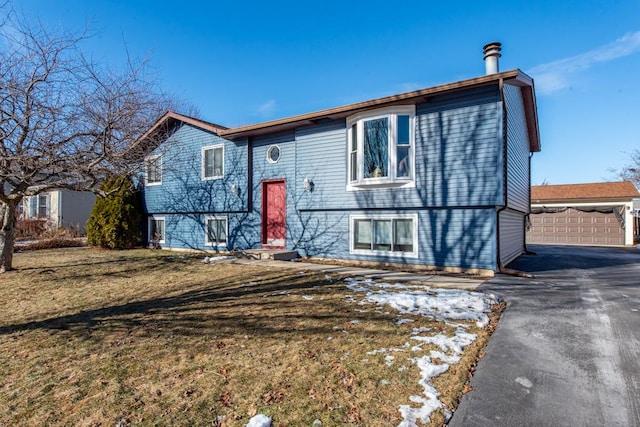 split foyer home with a garage and a front lawn