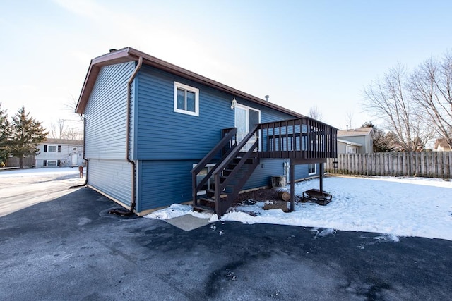 view of front of house featuring a wooden deck and central AC unit