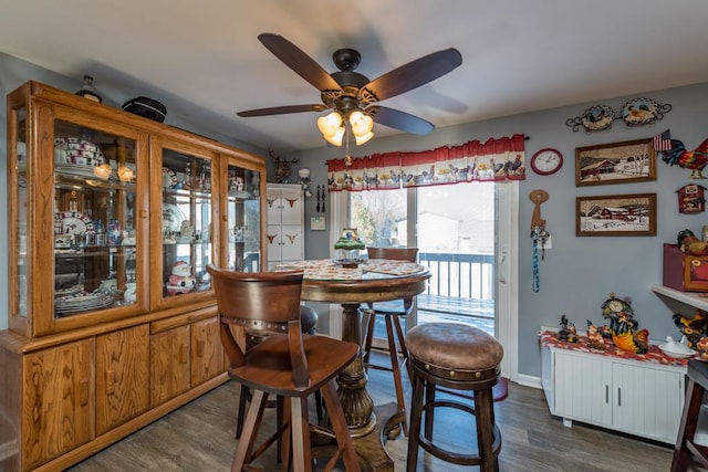 dining space with dark hardwood / wood-style floors and ceiling fan