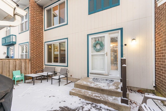 view of snow covered property entrance