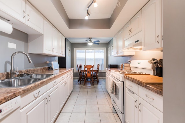 kitchen featuring rail lighting, sink, light tile patterned floors, white appliances, and white cabinets