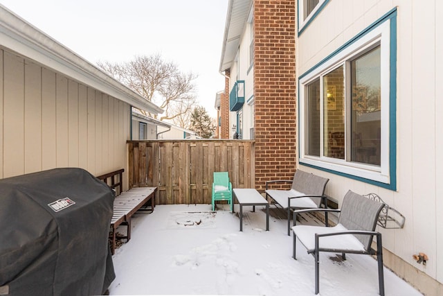 snow covered patio with grilling area