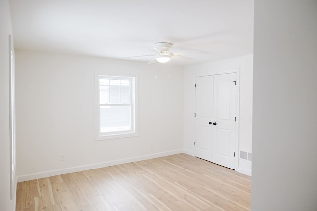 empty room featuring ceiling fan and light wood-type flooring