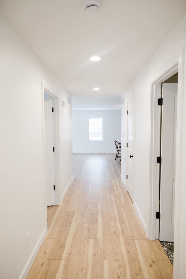 hallway with light wood-type flooring