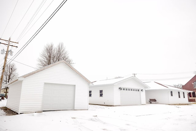 view of front facade with a garage and an outbuilding