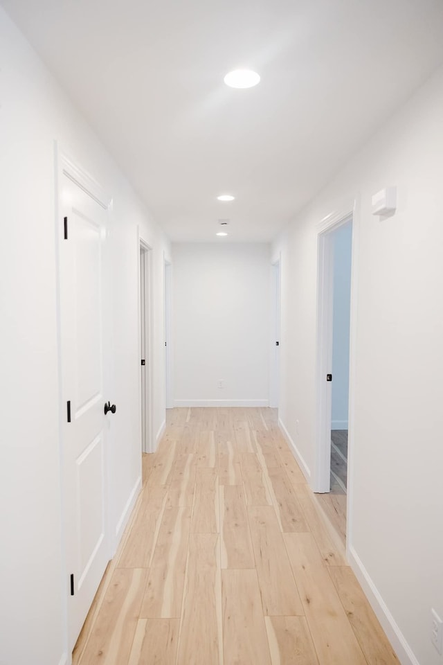 corridor with light hardwood / wood-style flooring