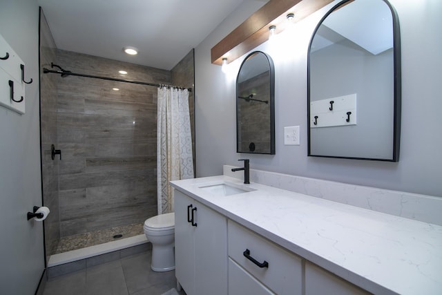 bathroom with walk in shower, vanity, and toilet