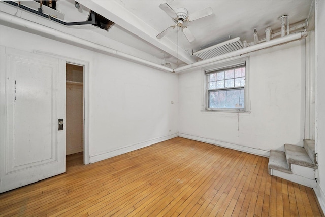 unfurnished room with wood-type flooring and ceiling fan