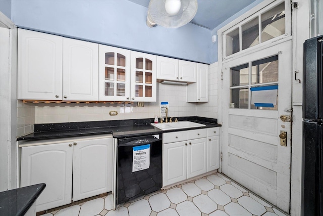 kitchen with white cabinets, sink, decorative backsplash, and black appliances