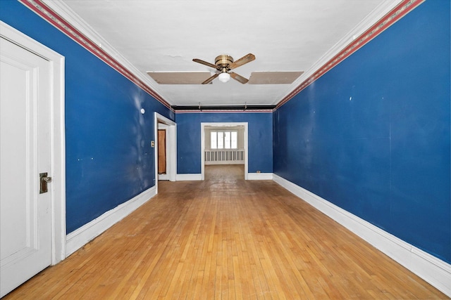 empty room featuring crown molding, ceiling fan, radiator, and hardwood / wood-style flooring