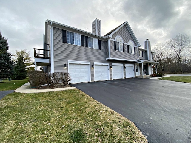 view of property exterior with a garage and a lawn