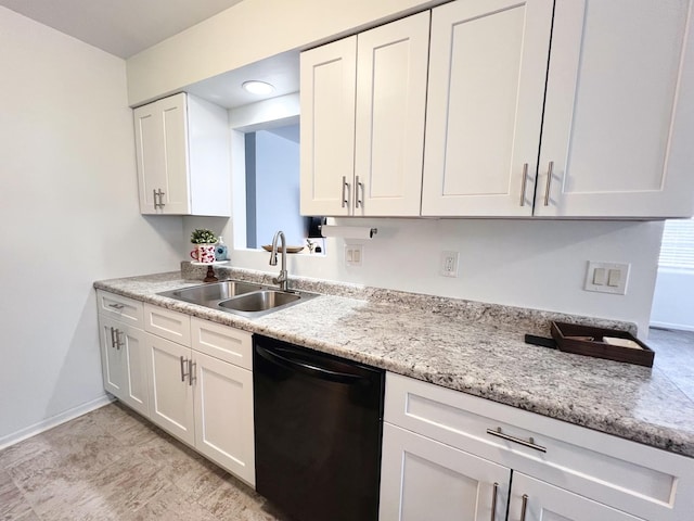 kitchen with white cabinets, light stone countertops, sink, and black dishwasher