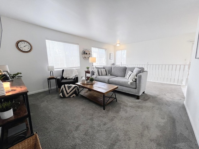 living room with dark colored carpet