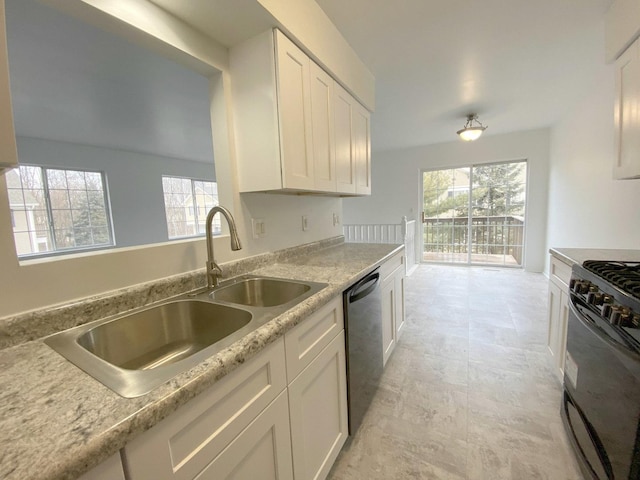 kitchen featuring dishwashing machine, sink, black range with gas cooktop, light stone counters, and white cabinets